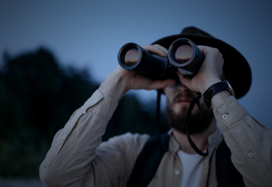 Investigator using binoculars at dusk